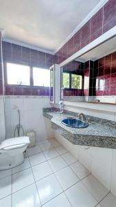 a bathroom with a sink and a toilet and a mirror at Hotel Internacional in Campo Grande +25 photos