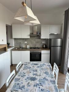 a kitchen with a table with a blue and white pattern at Villetta Zuccale 6 in Capoliveri +15 photos