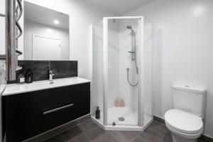 a bathroom with a shower and a sink and a toilet at Chic Urban Retreat in Grey Lynn in Auckland