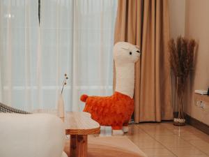 a stuffed giraffe standing in a living room at Gee homestay in Kota Kinabalu