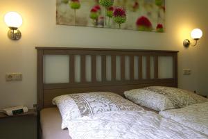 a bed in a bedroom with two pillows on it at Adams Schwedenhaus in Dechow