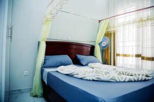 a bedroom with a bed with a canopy at Comfort away from home in Bujumbura