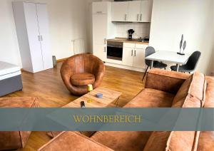a living room with a couch and a table at Flexi Flats in Lingen +5 photos