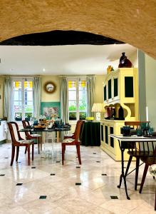 a kitchen with a dining room with tables and chairs at Le Logis Plantagenêt in Bergerac