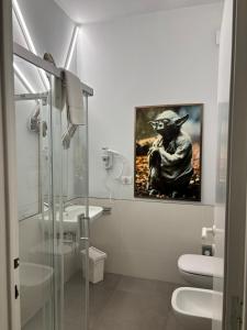 a bathroom with a yoda painting on the wall at Red Carpet rooms in Bari