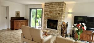 a living room with a couch and a fireplace at Maison de Vacances en bord de mer in Saint-Gildas-de-Rhuys