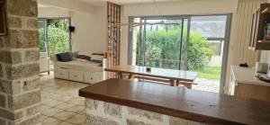 a living room with a table and a couch at Maison de Vacances en bord de mer in Saint-Gildas-de-Rhuys