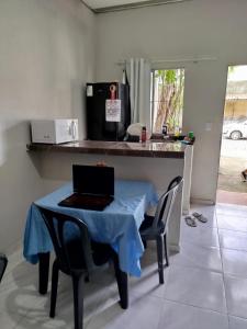 a kitchen with a table with a laptop on it at Flat em são Brás COP30 in Belém