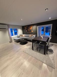 a living room with a table and a couch at Private house in Orkanger, 35 minutes from Trondheim in Orkanger
