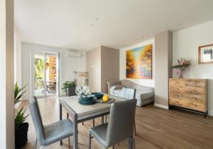 a dining room and living room with a table and chairs at Vatican family loft in Rome