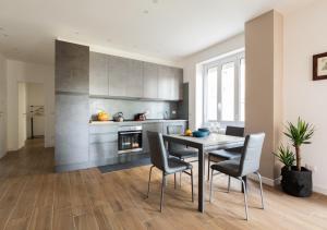 a kitchen with a table and chairs in a room at Vatican family loft in Rome