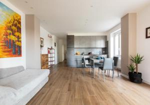 a living room with a couch and a table with chairs at Vatican family loft in Rome