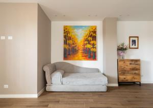 a couch in a room with a painting on the wall at Vatican family loft in Rome
