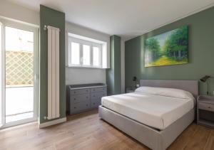 a bedroom with a bed and a painting on the wall at Vatican family loft in Rome +7 photos