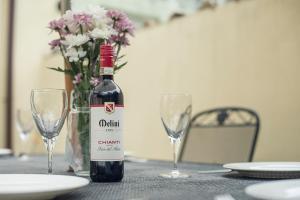 a bottle of wine sitting on a table with glasses at 3 The Glen in Saundersfoot