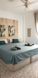 a bedroom with a large bed with a keyboard on it at Acogedor apartamento de playa in Puerto de Mazarrón