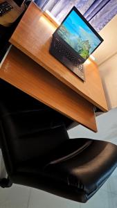a laptop computer sitting on top of a desk at River View Bangkok in Bangkok