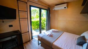 Posteľ alebo postele v izbe v ubytovaní Concept Village Piccola Gardiola
