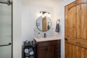 a bathroom with a sink and a mirror at Pine Cone Cottage in Hamptonville +33 photos