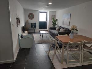 a living room with a table and a couch at Fisherman's Inn in Montijo