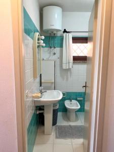 a small bathroom with a sink and a toilet at Casa Terrazza sul Golfo in Cannigione