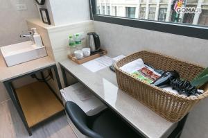 a bathroom with a counter with a sink and a desk at Meng Yun Ge Hotel in Jiaoxi
