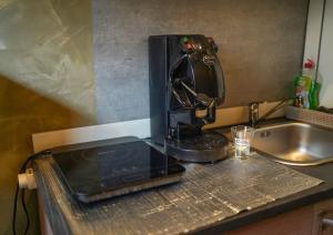 a coffee maker sitting on a counter next to a sink at Binario 14 Piazza Garibaldi in Naples +64 photos