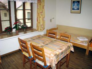 a dining room with a table and two beds at Penzion u muzea in Příbram