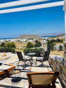 a patio with tables and chairs and a table at Irini's House Sunbeam in Dhragoulás
