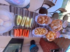 a bunch of plates of food on a table at pousada vila das oliveiras in Pirenópolis
