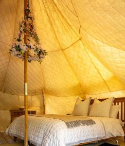 a bedroom with a tent with a bed at Alum House Littlebeck Glamping Whitby in Whitby