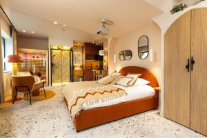 a bedroom with a large bed and a kitchen at Suite romantique Ibiza, Jacuzzi, Spa in Strasbourg