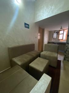a waiting room with couches and chairs in a room at Entire studio close to Sale, Marina, beach and transportation in Sale