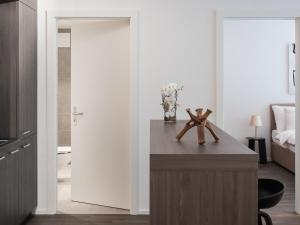 a room with a table with a vase of flowers at Modern apartment - Luxury residence in La Paudèze in Paudex +39 photos