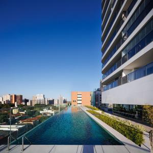 a view of a pool in the middle of a building at White 2880 - Pinheiros in Sao Paulo