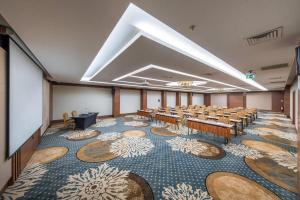a conference room with rows of tables and chairs at Holiday Inn Ankara - Cukurambar by IHG in Ankara +51 photos