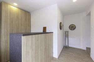 a hallway with a wooden counter in a room at Alle Arce in Domegge di Cadore