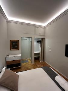 a bedroom with a bed and a flat screen tv at Suite Florio in Turin