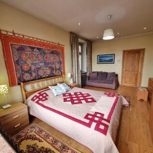 a bedroom with a large bed and a couch at Goyo Apartment - Flower, Ulaanbaatar in Ulaanbaatar