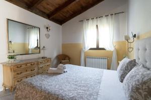 sypialnia z dużym łóżkiem z pluszowym misiem w obiekcie El Manantial Del Fresno Casas Rurales En Hervás - Piscina - Desayunos - Barbacoa - Parking gratis w mieście Hervás +25 zdjęć