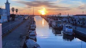 a group of boats docked in a canal at sunset at Lovely Versilia in Torre del Lago Puccini