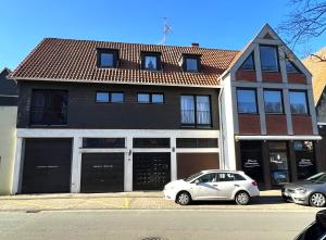 a white car parked in front of a building at Ferienwohnung 9 Torster - im Zentrum der Altstadt in Hameln