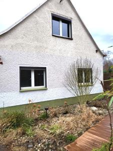 a house with two windows on the side of it at Monteur-Haus Heinrich Berlin Marzahn, Hellersdorf, Lichtenberg in Berlin