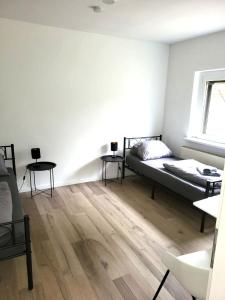 a bedroom with a bed and two tables in it at Monteur-Haus Heinrich Berlin Marzahn, Hellersdorf, Lichtenberg in Berlin