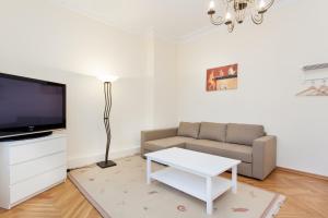 a living room with a couch and a flat screen tv at GreatStay Apartment - Bornstedterstr. in Berlin