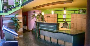 a kitchen with a counter in a room with stairs at Adeo Hostel in Białystok