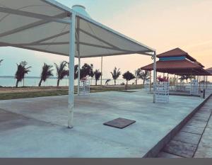 a pavilion with tables and chairs on the beach at Yanam resorts in Yanam