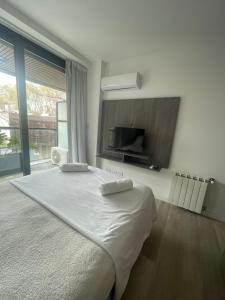 a bedroom with a large bed and a large window at Departamento Nuevo en Palermo Soho in Buenos Aires