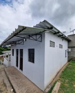 a white house with awning on top of it at Apartamento em Presidente Figueiredo in Presidente Figueiredo