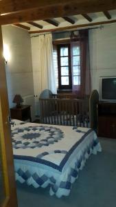 a bedroom with a bed with a table and a window at La Maison de Yana in Saint-Marcel-dʼArdèche